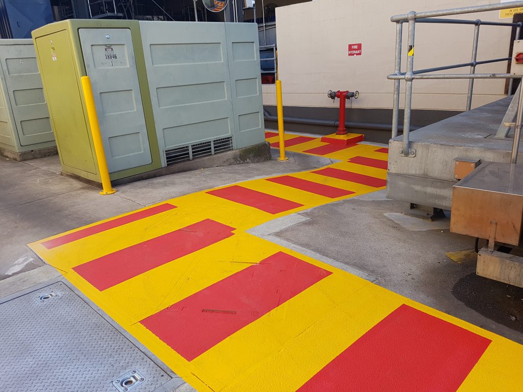 linemarking pedestrian walkways at lion penrith using dulux waterborne after grinding.