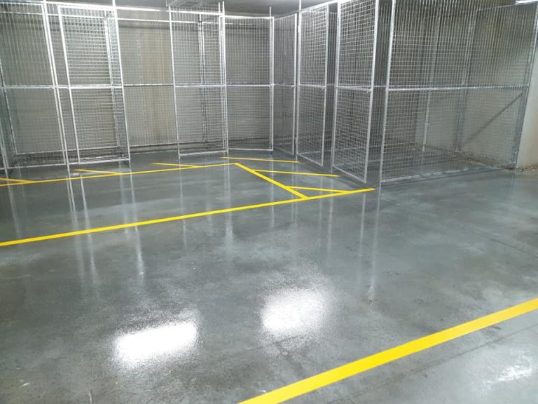 A spacious storage room featuring yellow lines on a concrete-sealed floor.