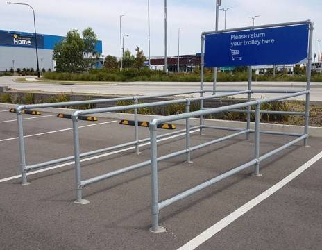 A parking lot featuring a clear sign that reads "parking," indicating designated parking spaces for vehicles.